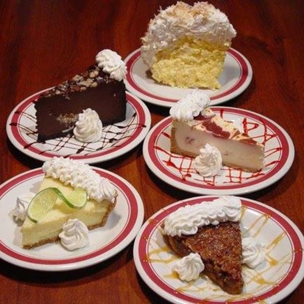 Five slices of Rib City desserts, including chocolate cake, key lime pie, and cheesecake.
